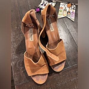 Worn Steve Madden tan short heels. Buckle straps with scuffs.
